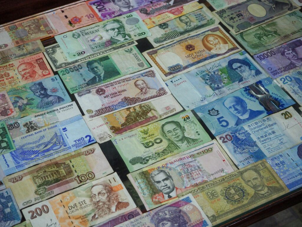 pexels-photo-5746260-5746260 From above collection of various colorful banknotes from different countries arranged in row on table